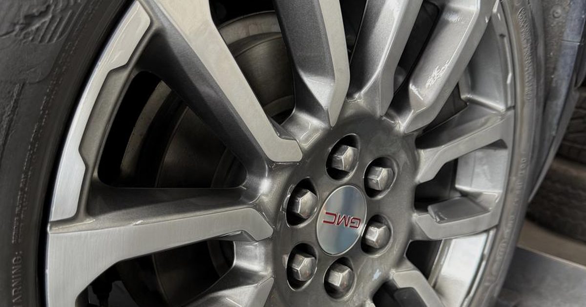 A GMC alloy wheel photographed after repair and refinishing at the Costa Mesa shop